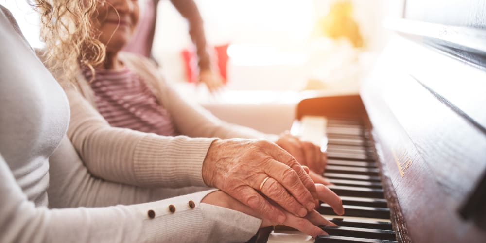 A resident and family member enjoying the Music Speaks Program at Arlington Place of Grundy Center in Grundy Center, Iowa.