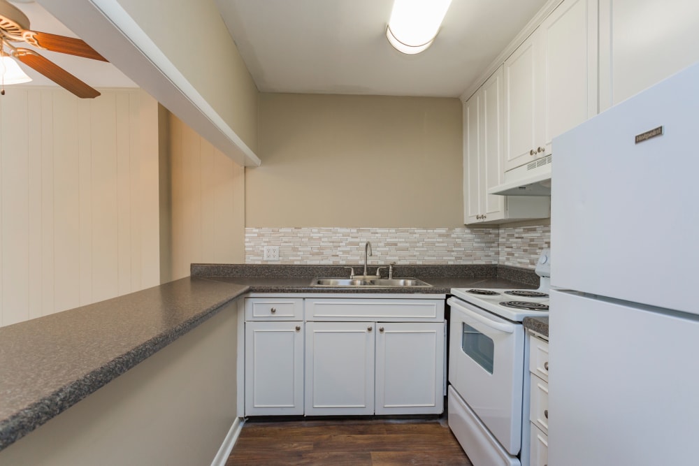 Kitchen with White Appliances at Belmont Place Apartments in Nashville, Tennessee