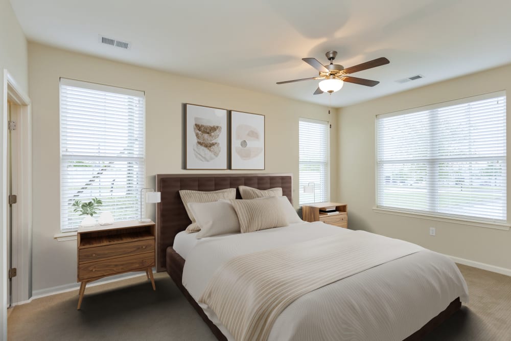 Bedroom with large closet doors and a ceiling fan at Madison Crest Apartment Homes in Madison, Tennessee