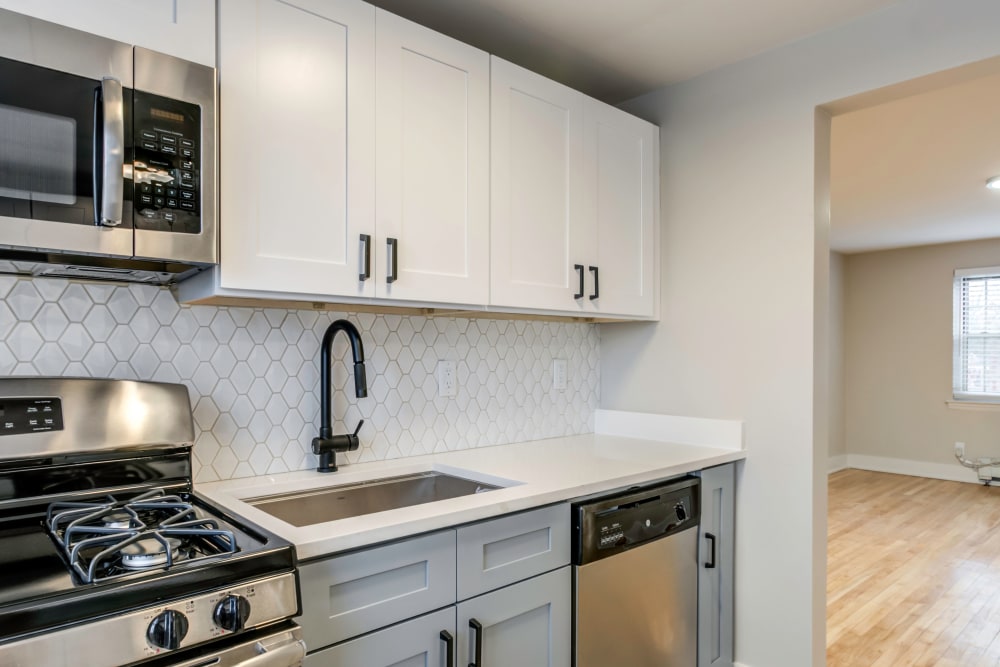 Kitchen with stainless-steel appliances and cream-colored cabinetry at Haven New Providence in New Providence, New Jersey