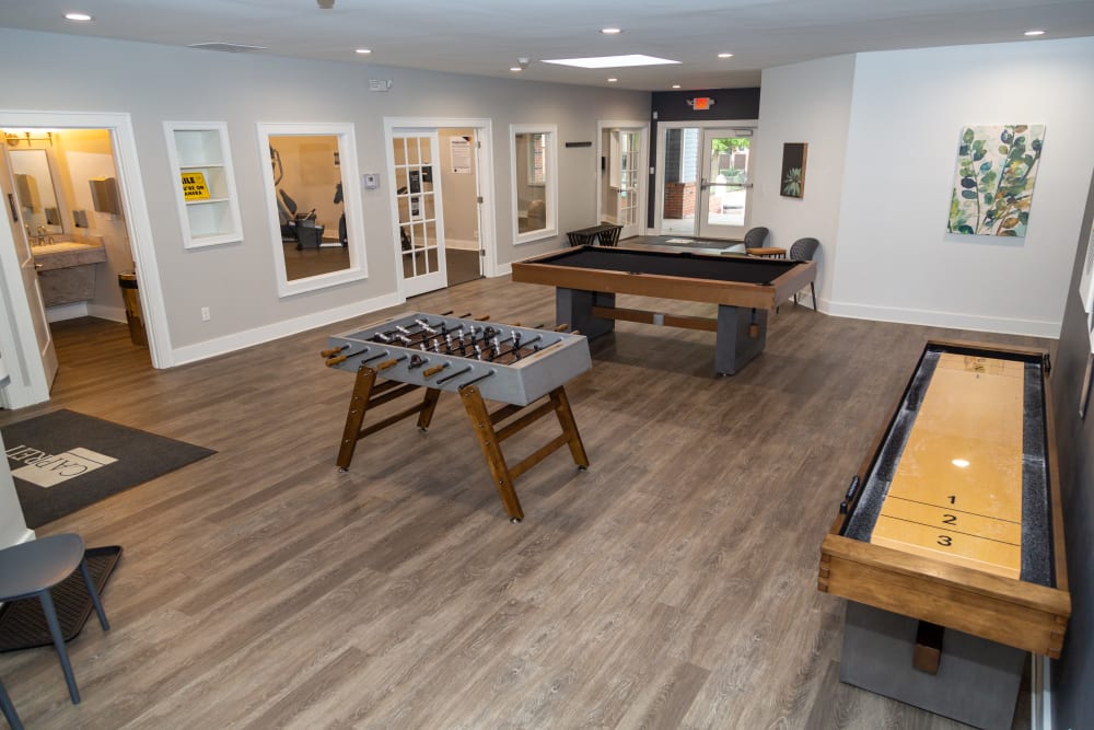 A community  clubhouse with a game room at Sunbrook Apartments in Saint Charles, Missouri