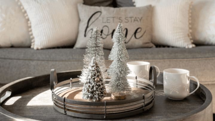 Christmas center piece on a coffee table with a couch in the background