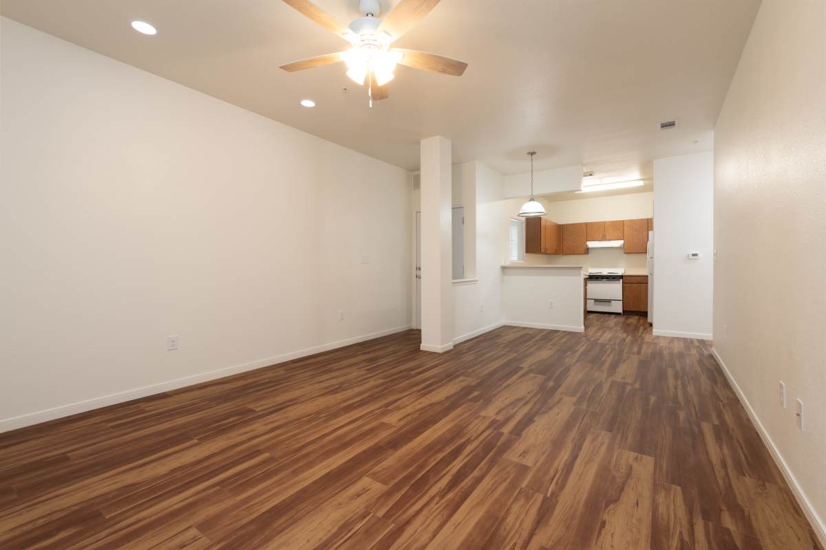 Unfurnished living room with view to kitchen at The Arbors at Rose Park in Abilene, Texas