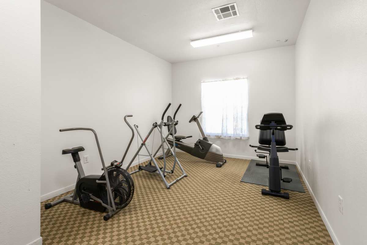Fitness center with cycling at The Arbors at Rose Park in Abilene, Texas
