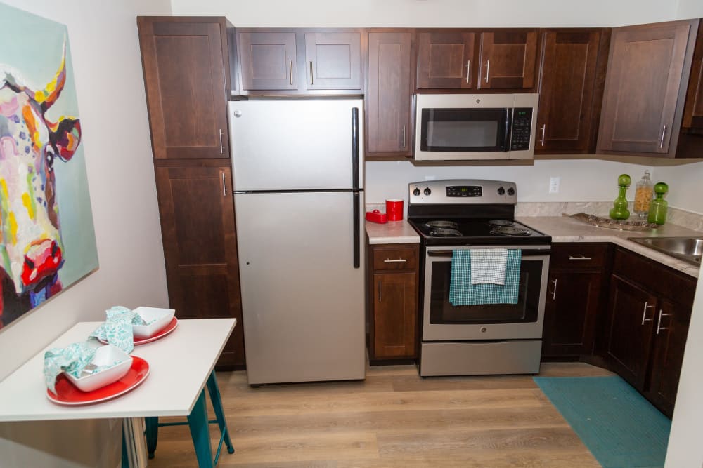 Open kitchen with plenty of cabinet space at Sunbrook Apartments in Saint Charles, Missouri