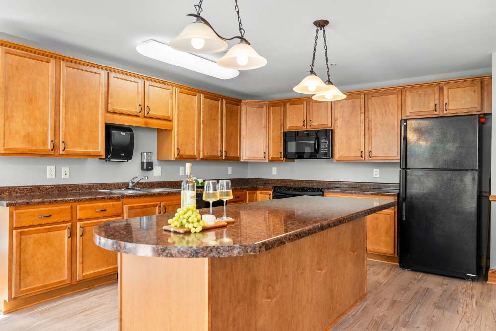 Rustic-style wooden kitchen with modern appliances at Amira Choice Roseville in Roseville, Minnesota