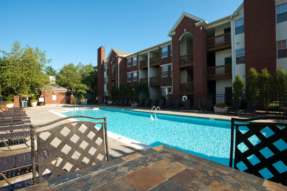 Table and chairs by the pool at Beaumont Farms Apartments in Lexington, Kentucky