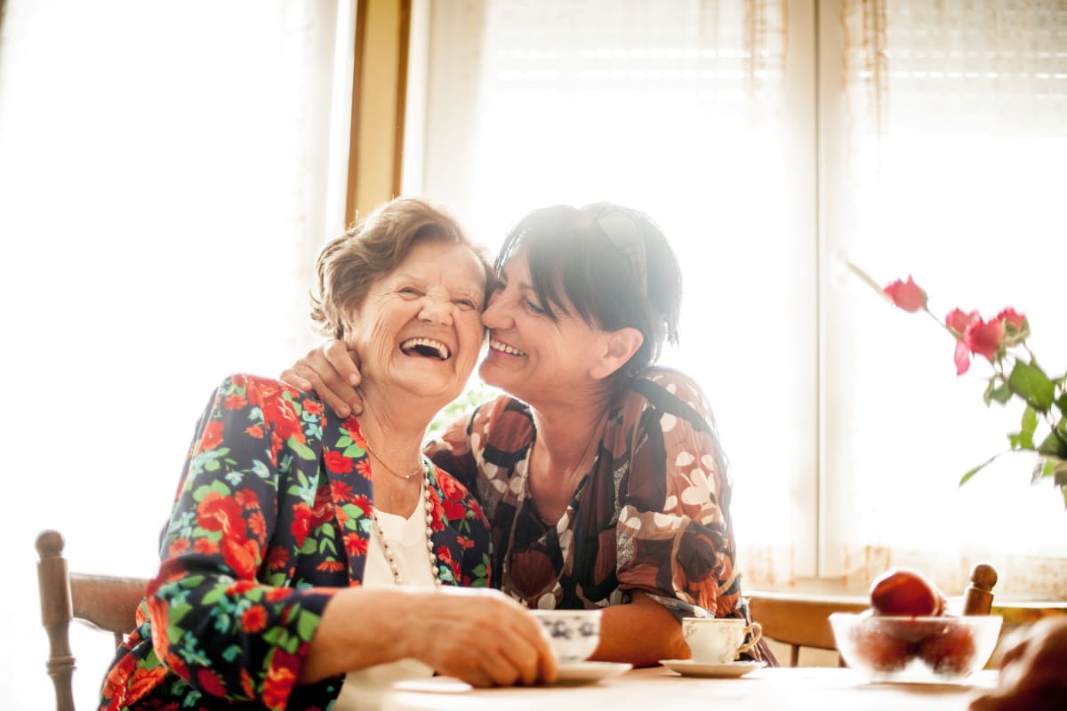 A daughter visiting with her mother at a Meridian Senior Living Assisted Living community