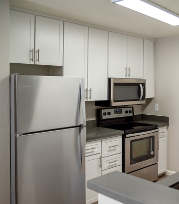 Kitchen with stainless-steel appliances with white cabinetry at Shaliko in Rocklin, California