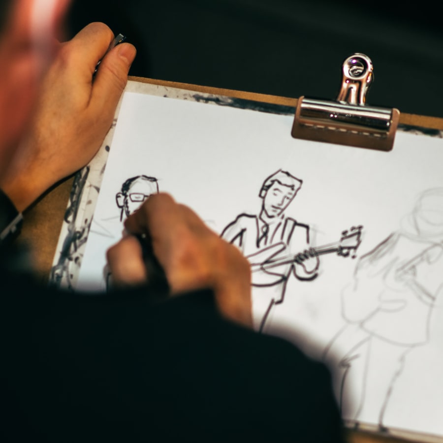 Artist drawing sketches of a band at 28 Exeter at Newbury in Boston, Massachusetts