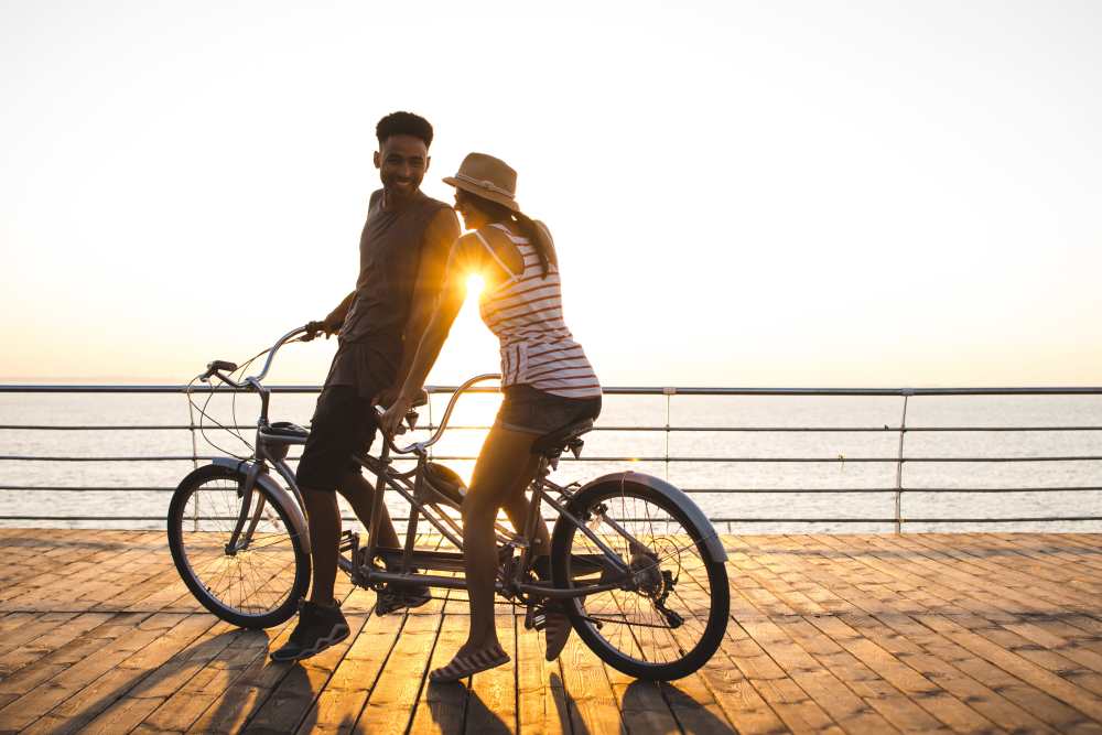 resident couple riding a bike oin the boardwalk near Avion Apartments in Jacksonville, Florida