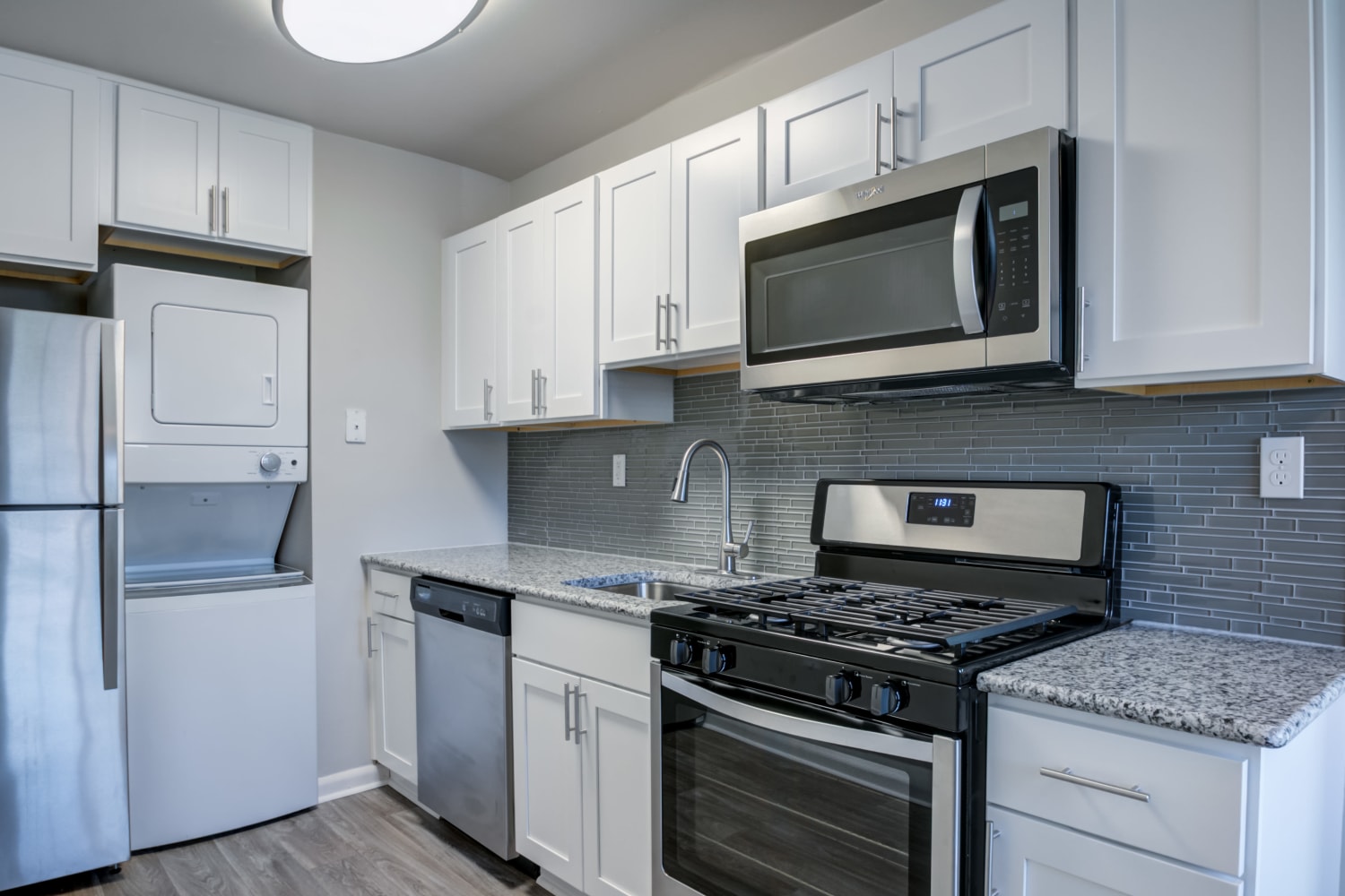 Modern kitchen with stainless-steel appliances and white cabinets at Eagle's Crest Apartments in Harrisburg, Pennsylvania