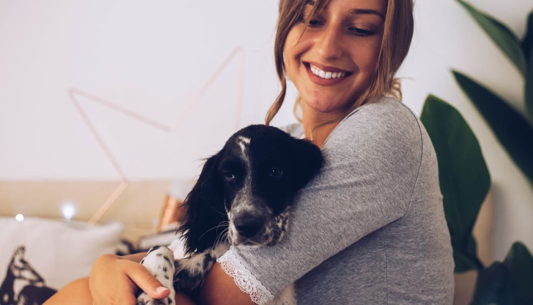 Resident and her dog at our pet-friendly apartments at MiLO at Mountain Park in Lake Oswego