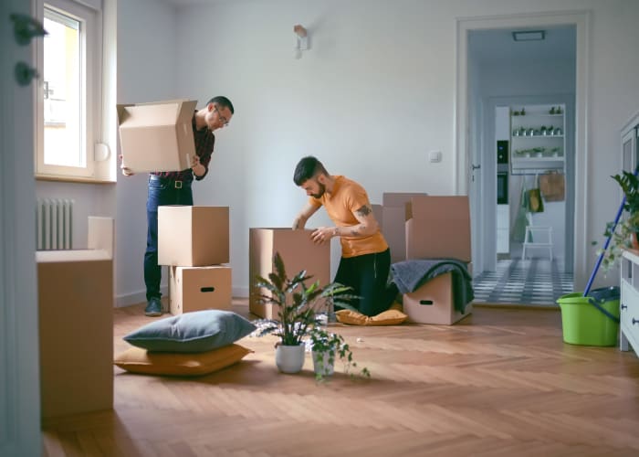 Two men pack belongings into boxes for storage at A Storage Place in Chino, California