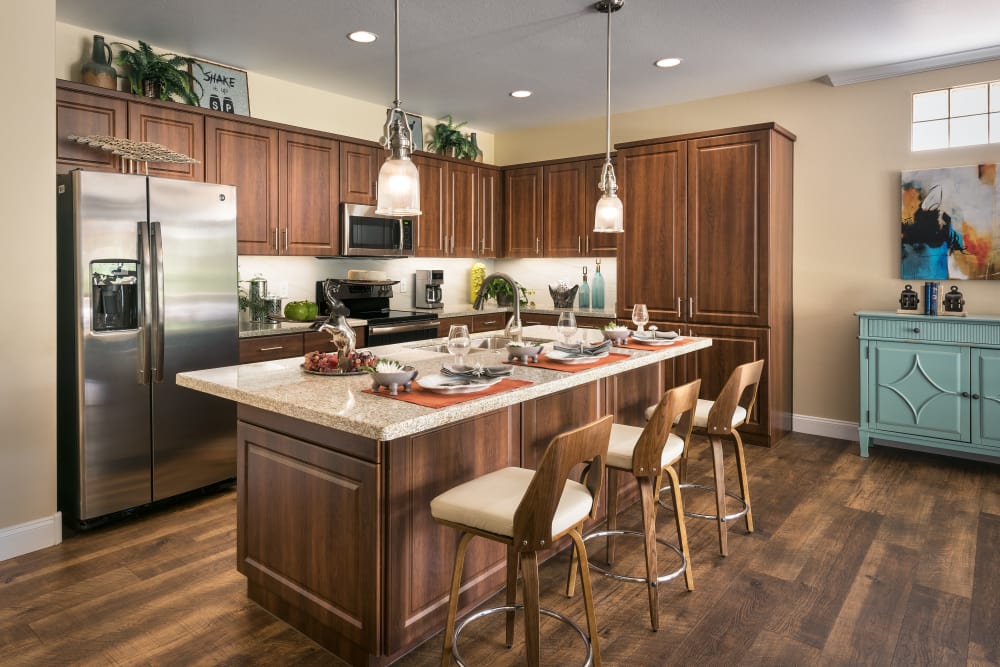 Gourmet kitchen with stainless-steel appliances in model home at San Portales in Scottsdale, Arizona