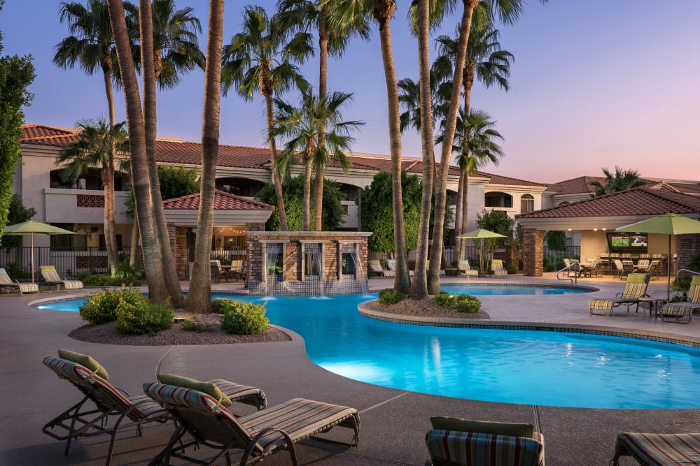 Gorgeous resort-style swimming pool with a water feature at San Prado in Glendale, Arizona