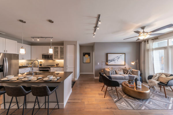 Beautiful open-concept layout with hand-scraped hardwood floors in a model home at Carter in Scottsdale, Arizona