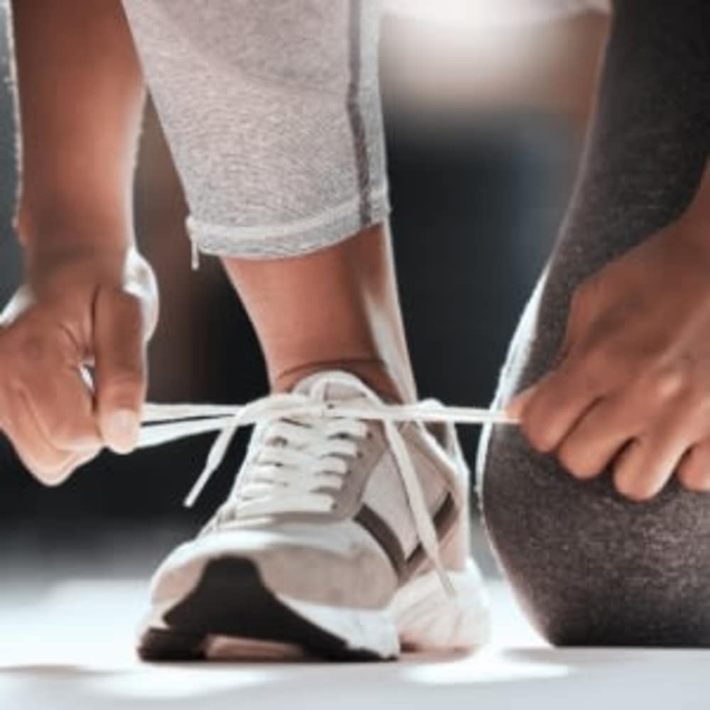 Woman tying her shoes laces at Vista in San Jose, California