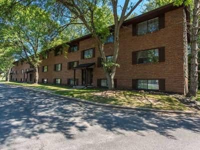 Exterior view of apartment building at The Residences at Covered Bridge in Liverpool, New York