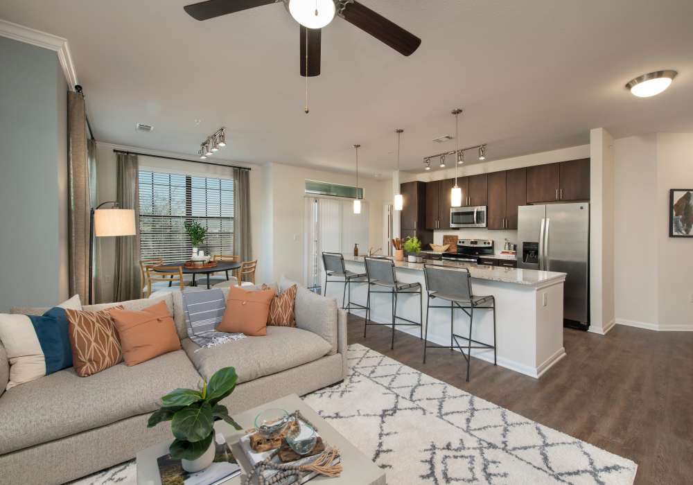 Living room with attached kitchen and breakfast counter at Nantucket at Fannin Station in Houston, Texas