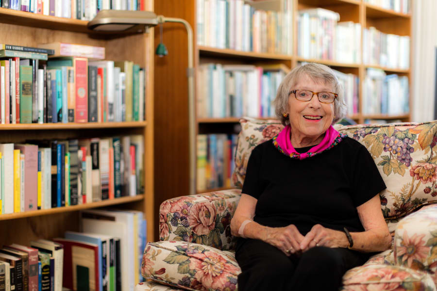 Resident next to a bookshelf at Palo Alto Commons in Palo Alto, California