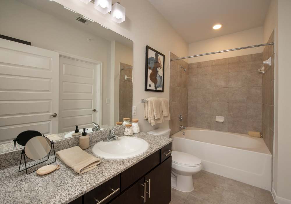 Minimalist bathroom with tile flooring at Nantucket at Fannin Station in Houston, Texas