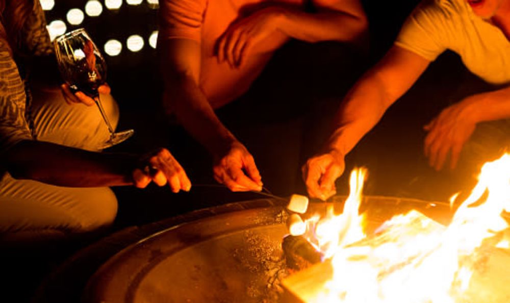 Residents enjoying the community fire pit at Timnath Trail at Riverbend Apartment Homes in Timnath, Colorado