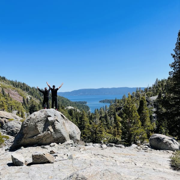 couple of people overlooking a scenic mountain view