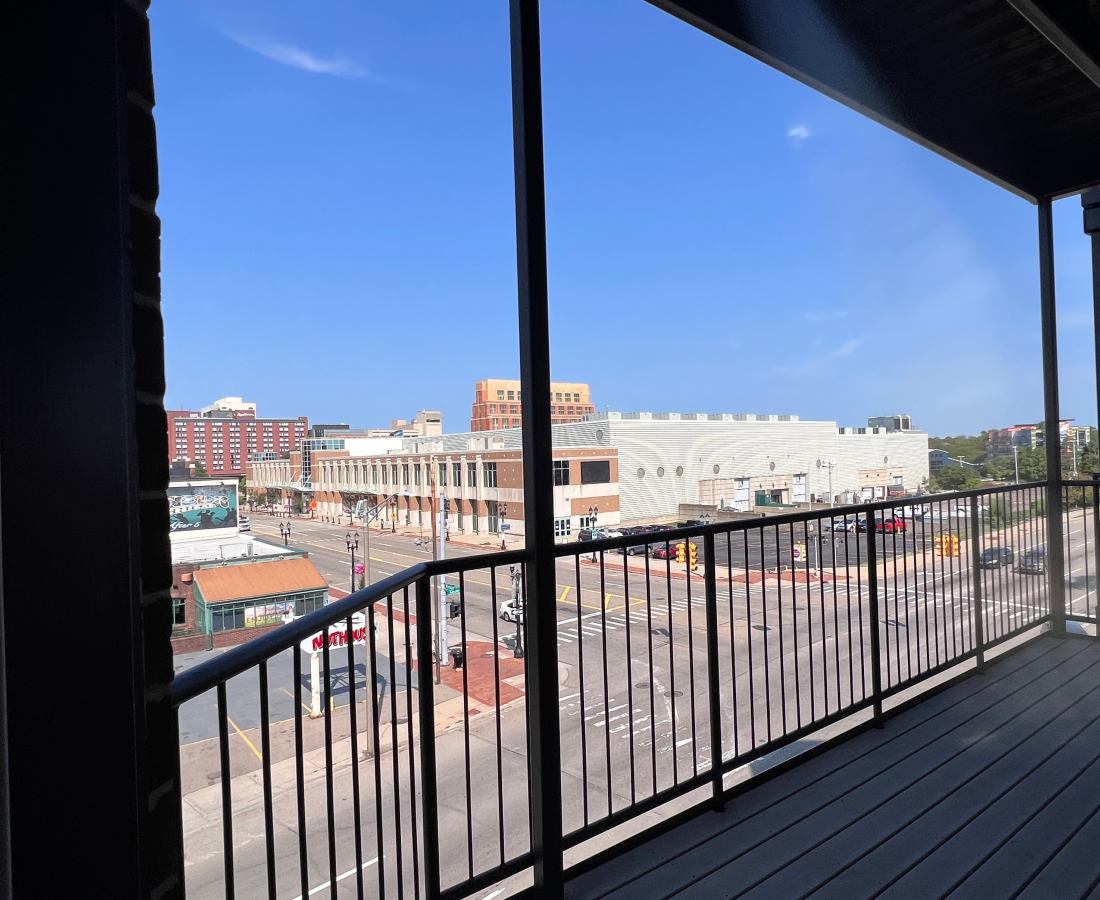 Apartment home balcony view overlooking city at Stadium District Apartments in Lansing, Michigan