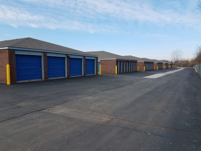 An exterior view of outdoor storage units with blue doors at U-Stor Belton in Belton, Missouri