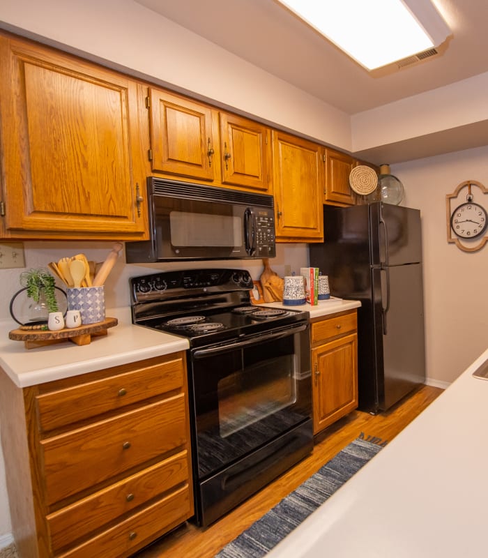 Kitchen with black appliances at Barrington Apartments in Tulsa, Oklahoma