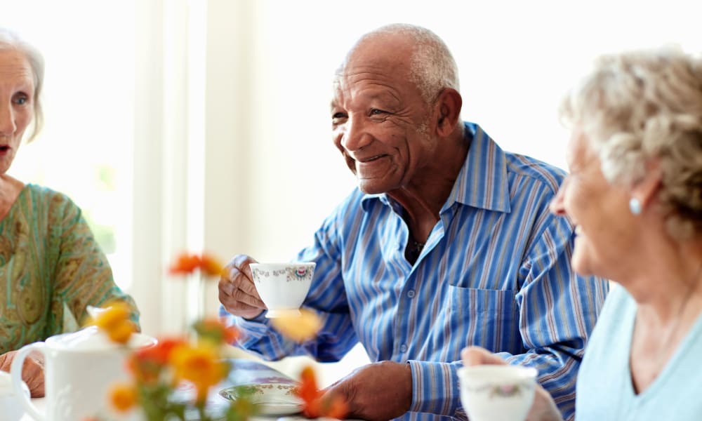 memory care resident enjoying tea with friends at Randall Residence