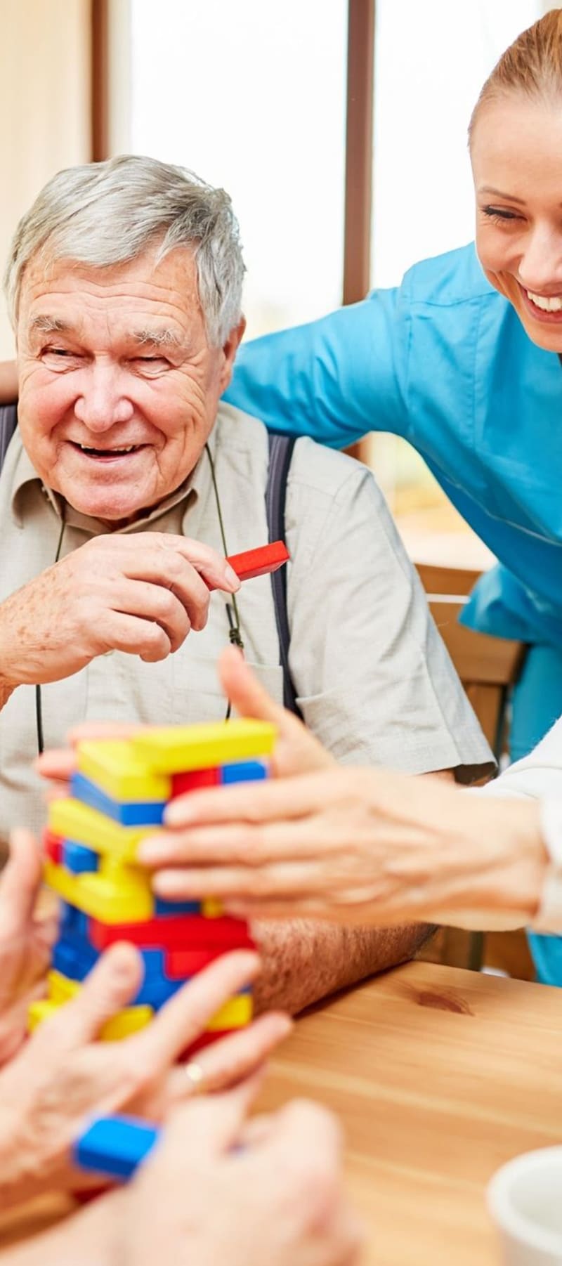 Residents sitting and talking with the help of a caretaker at Retirement Ranch in Clovis, New Mexico