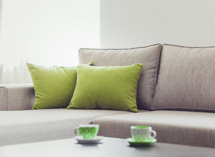 Comfortable couch with green pillows at Canyon View in Las Vegas, Nevada