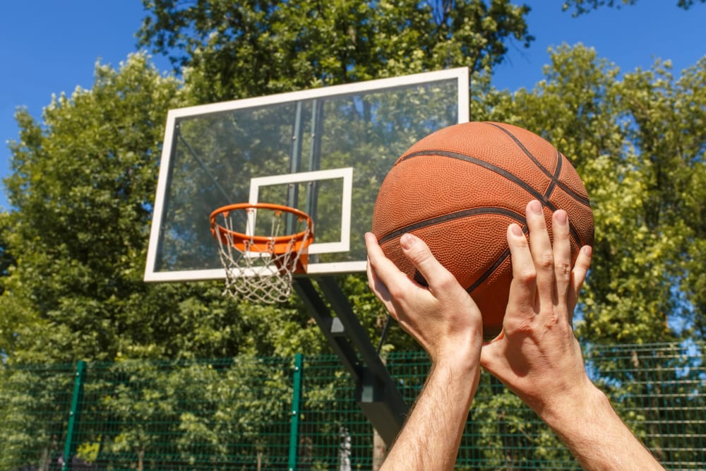 A resident playing basketball on a court at Prospect View in Lakeside, California