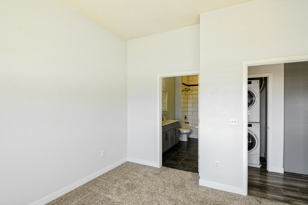 Bedroom with glimpse of Washer & Dryer at Steelyard Apartments in St. Louis, Missouri