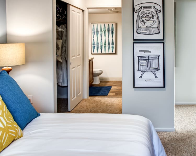 Master bedroom with plush carpeting and an en suite bathroom in a model home at Sofi at Cedar Mill in Portland, Oregon