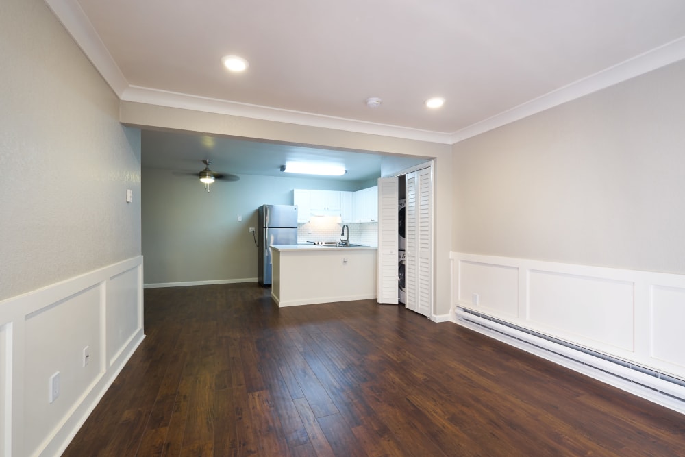 Spacious living room with hardwood floors at Breakwater Apartments in Santa Cruz, California