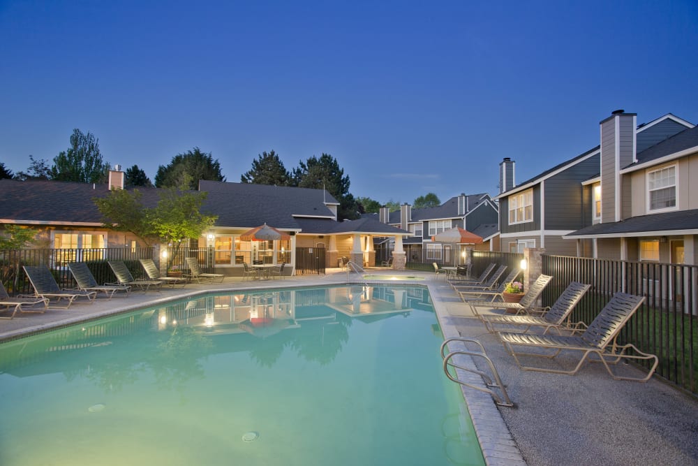 Swimming pool at dusk at Slate Ridge at Fisher's Landing Apartment Homes in Vancouver, Washington