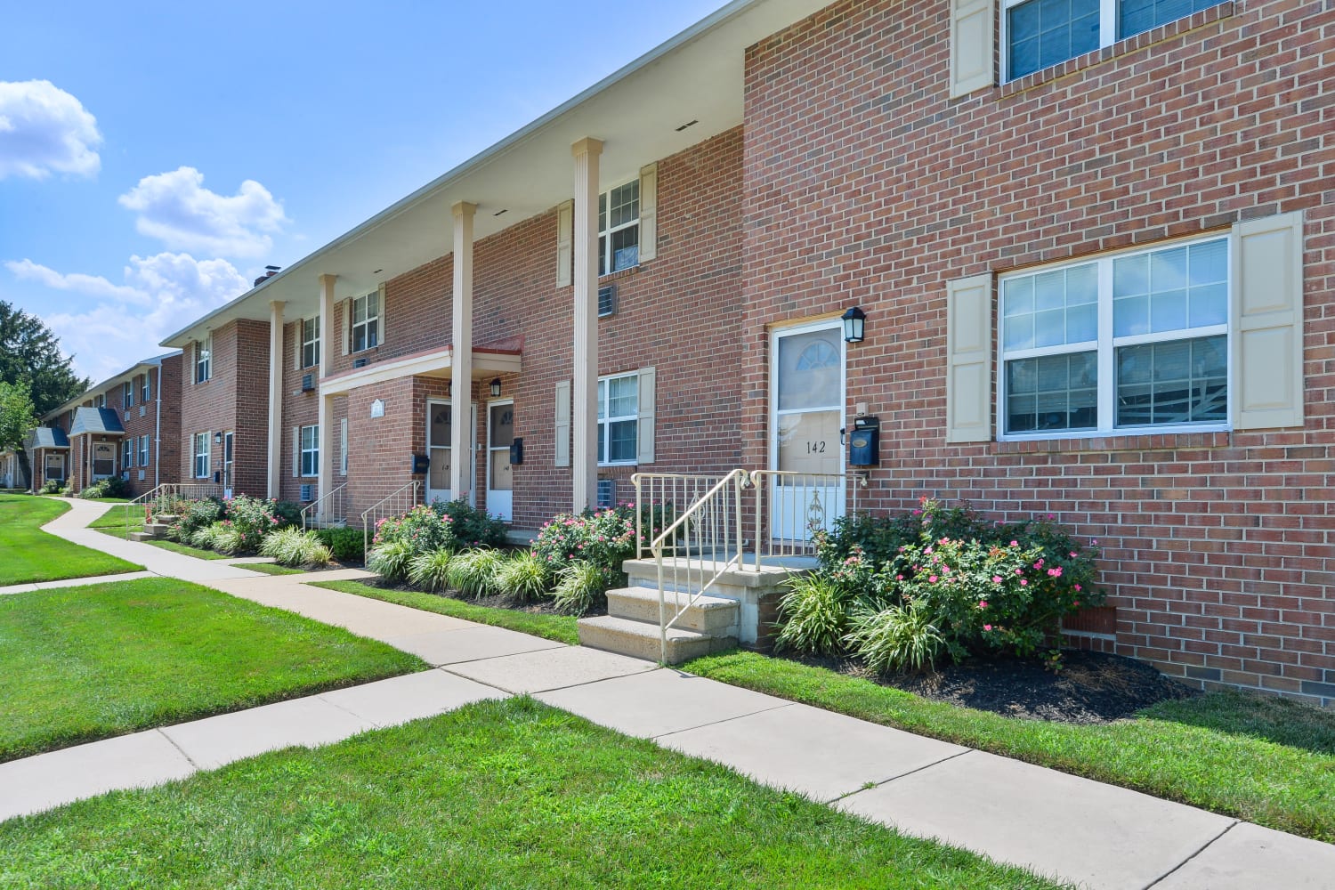 Apartment exterior with lawn at Roberts Mill Apartments & Townhomes in Maple Shade, New Jersey