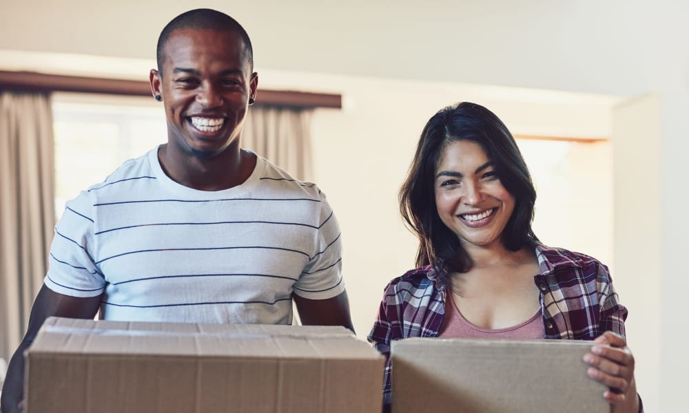 A couple packing up boxes to be moved to a Stop-N-Go Storage Management location