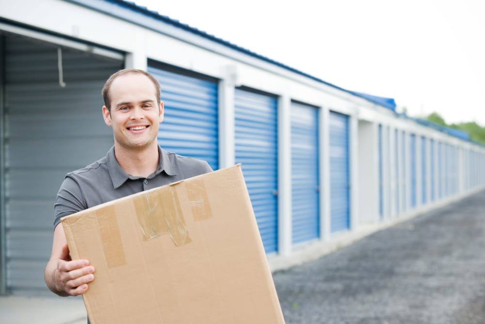 A man with a box in front of an easy-lift door unit at Battle Ground Mini Storage in Battle Ground, Washington