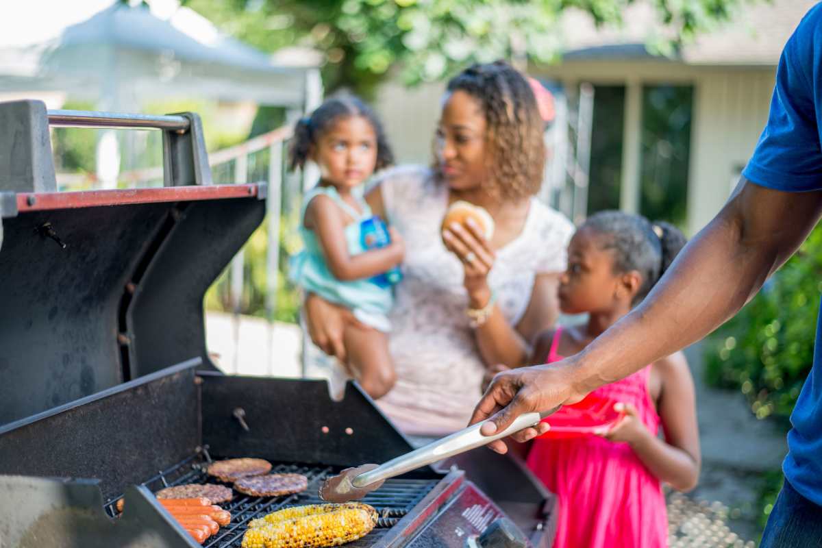 Resident at barbecue area at Hampton Village in Palestine, Texas