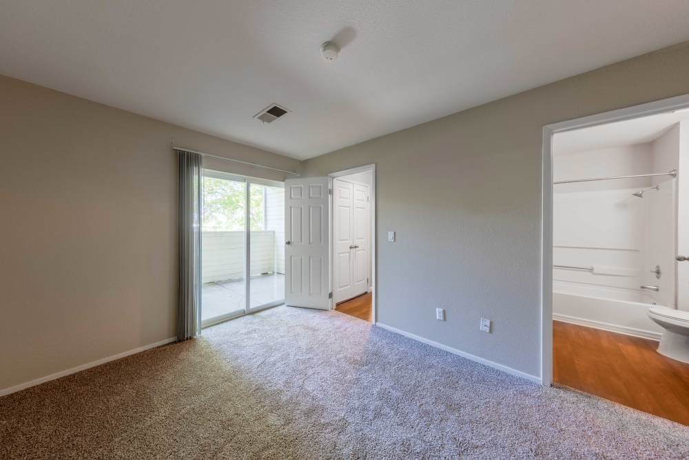 Carpeted bedroom with bathroom at The Lodge at McCarran Ranch Apartment Homes in Reno, Nevada