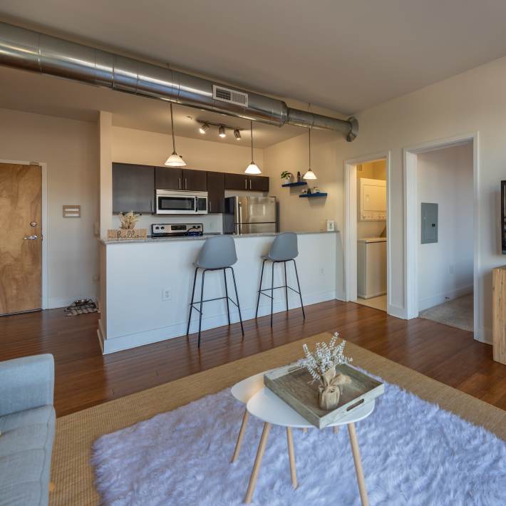 Kitchen with wooden cabinets and refrigerator at Attain Shockoe, Richmond, Virginia  