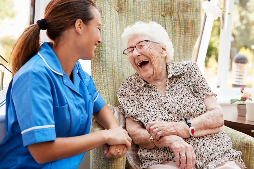 Resident and a nurse sitting outside talking at Randall Residence of Sterling Heights in Sterling Heights, Michigan