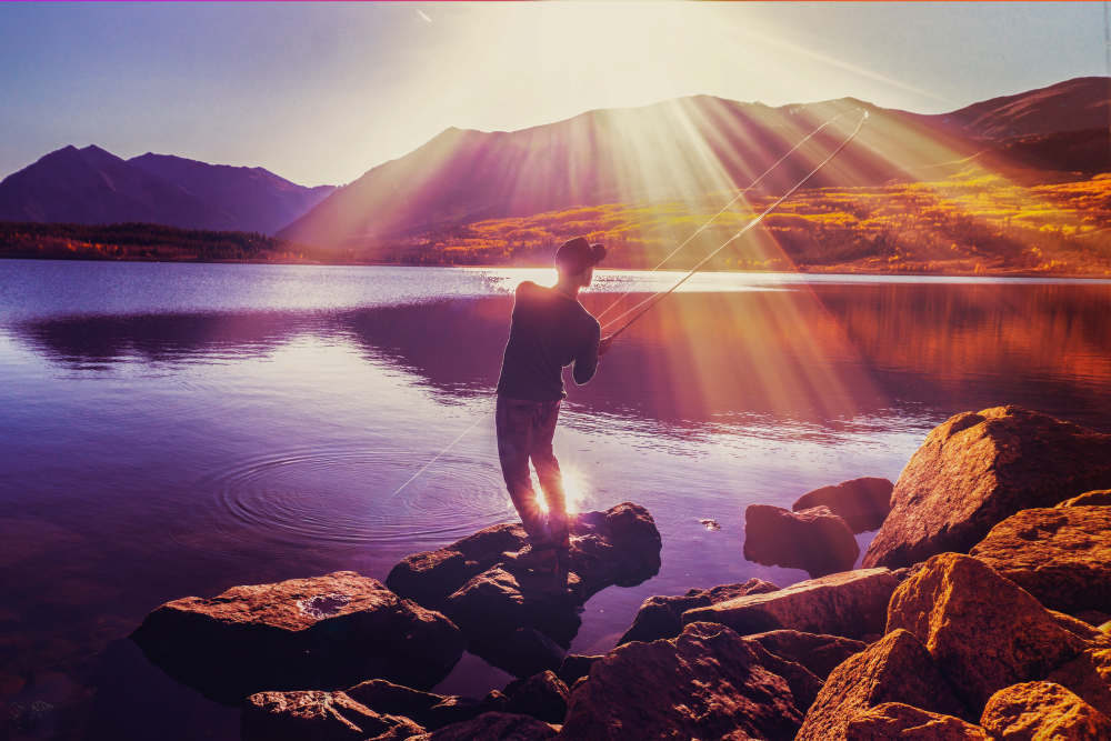 Man fishing at a beautiful lake near The Lock at Flatirons in Broomfield, Colorado