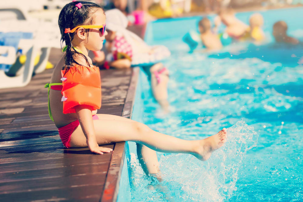 Resident child dipping her feet in the pool at Canyon View in Las Vegas, Nevada