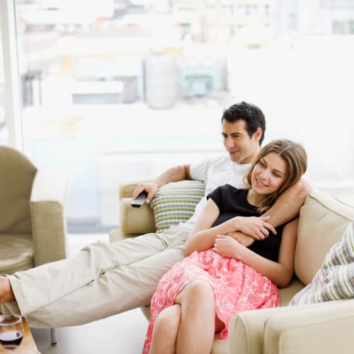 A couple laying down on couch at Joshua Heights in Twentynine Palms, California