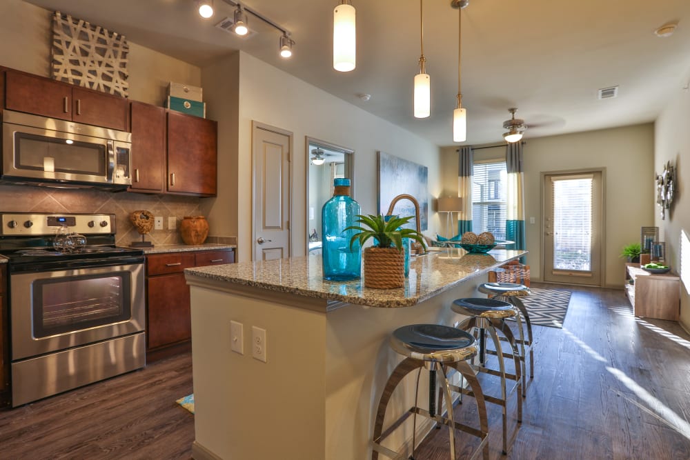 Gourmet kitchen with quartz countertops in a model home at Olympus at Waterside Estates in Richmond, Texas